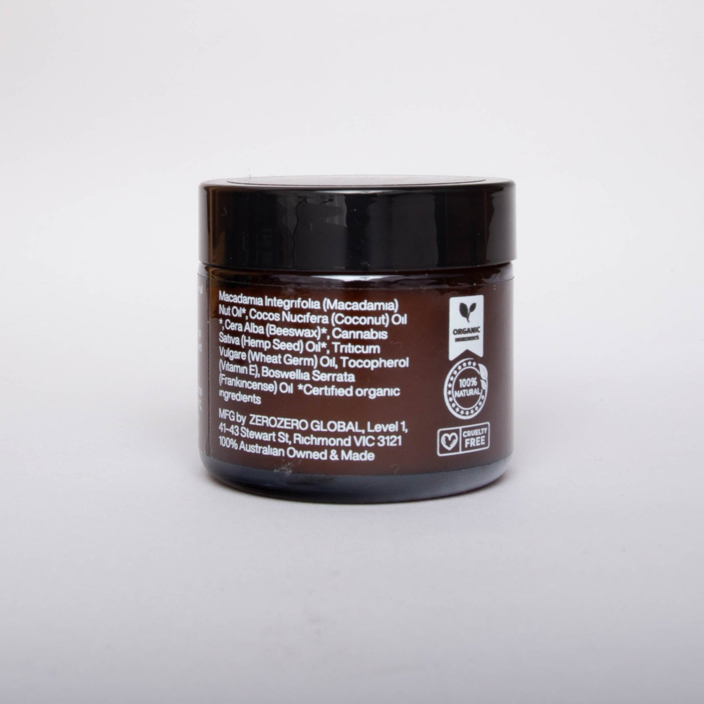 Amber glass cosmetics jar with black lid and white writing with ingredients and the product certifications. 