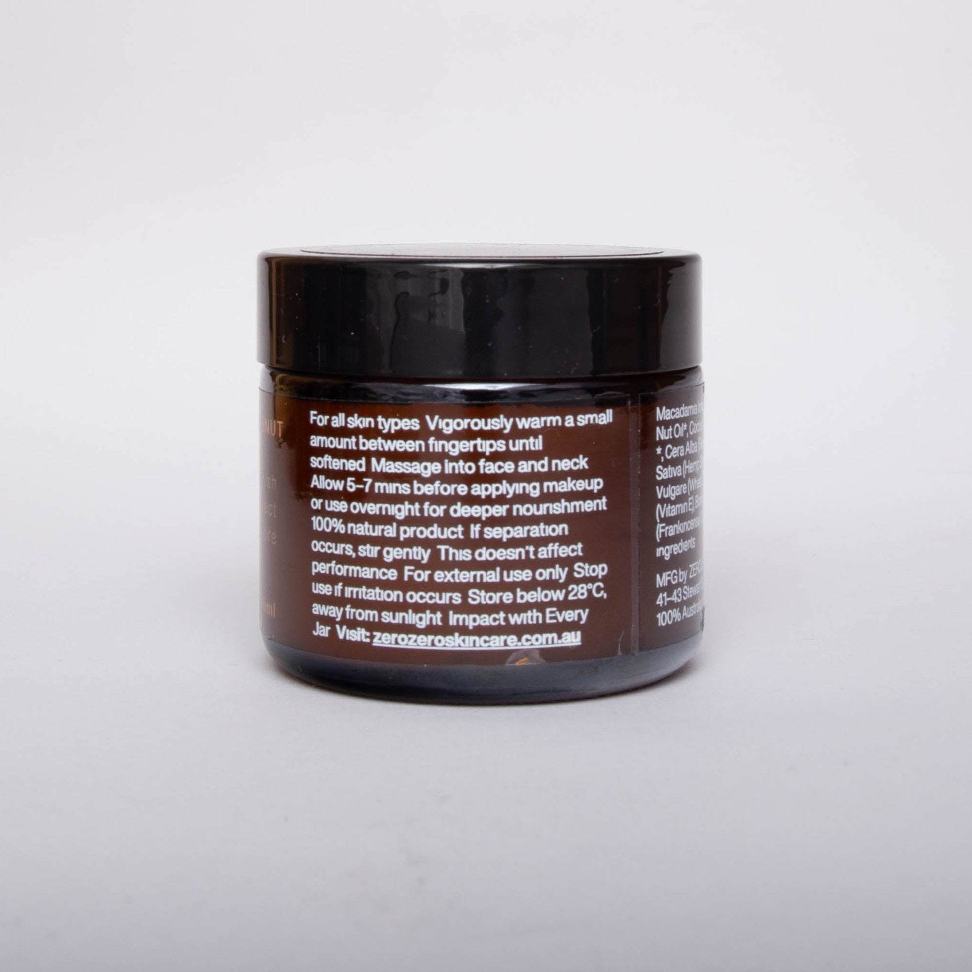Amber glass cosmetics jar with black lid and white writing with instructions on how to use.