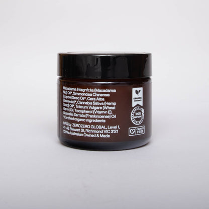 Amber glass cosmetics jar with black lid and white writing with ingredients and the product certifications. 